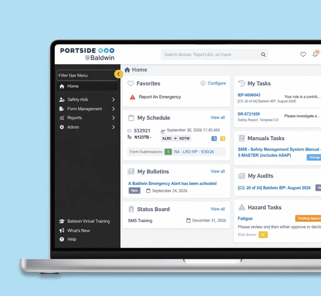 Baldwin SMS software interface on a laptop displaying the main safety management dashboard, pending tasks, emergency alerts, and hazard tracking.